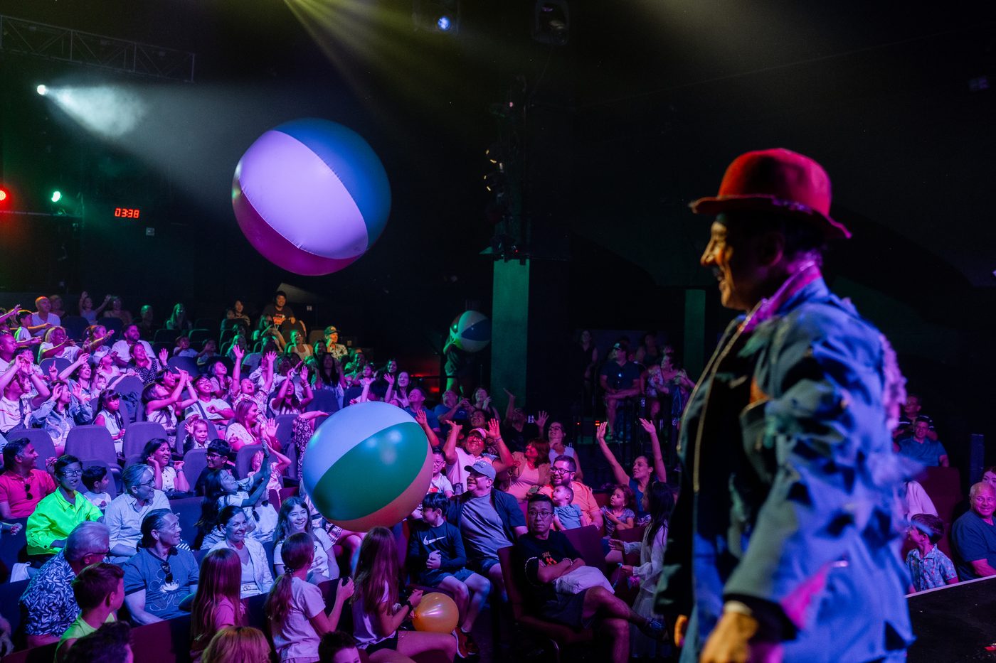 The audience reaching for the beach balls