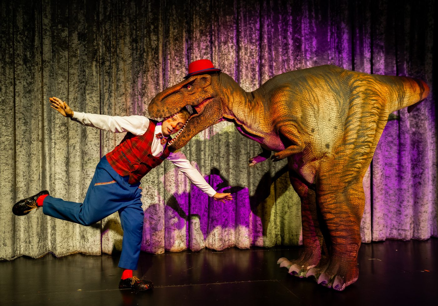 Rescue Dino chases the clown across the stage
